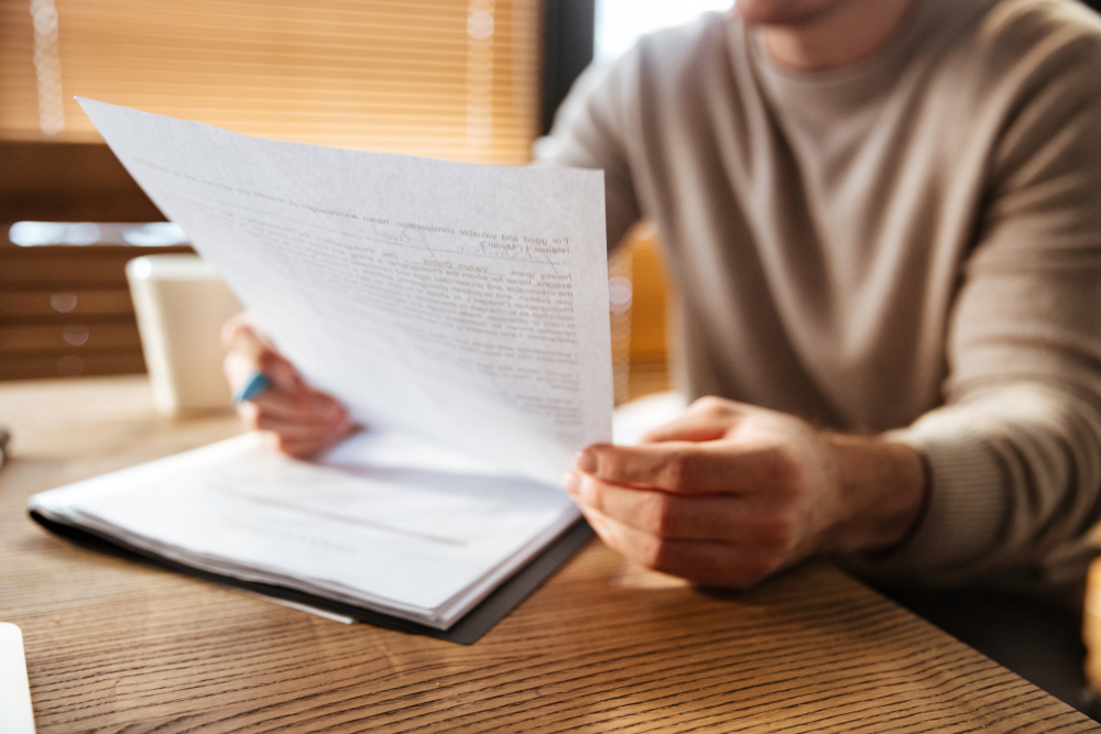 Homem segurando a escritura do imóvel